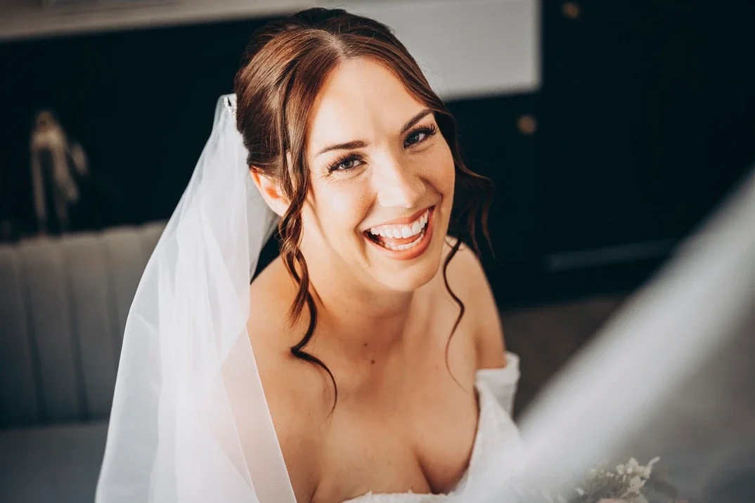 Claire Field Bridal Hair and Make up. Dressed in a wedding gown with a veil.