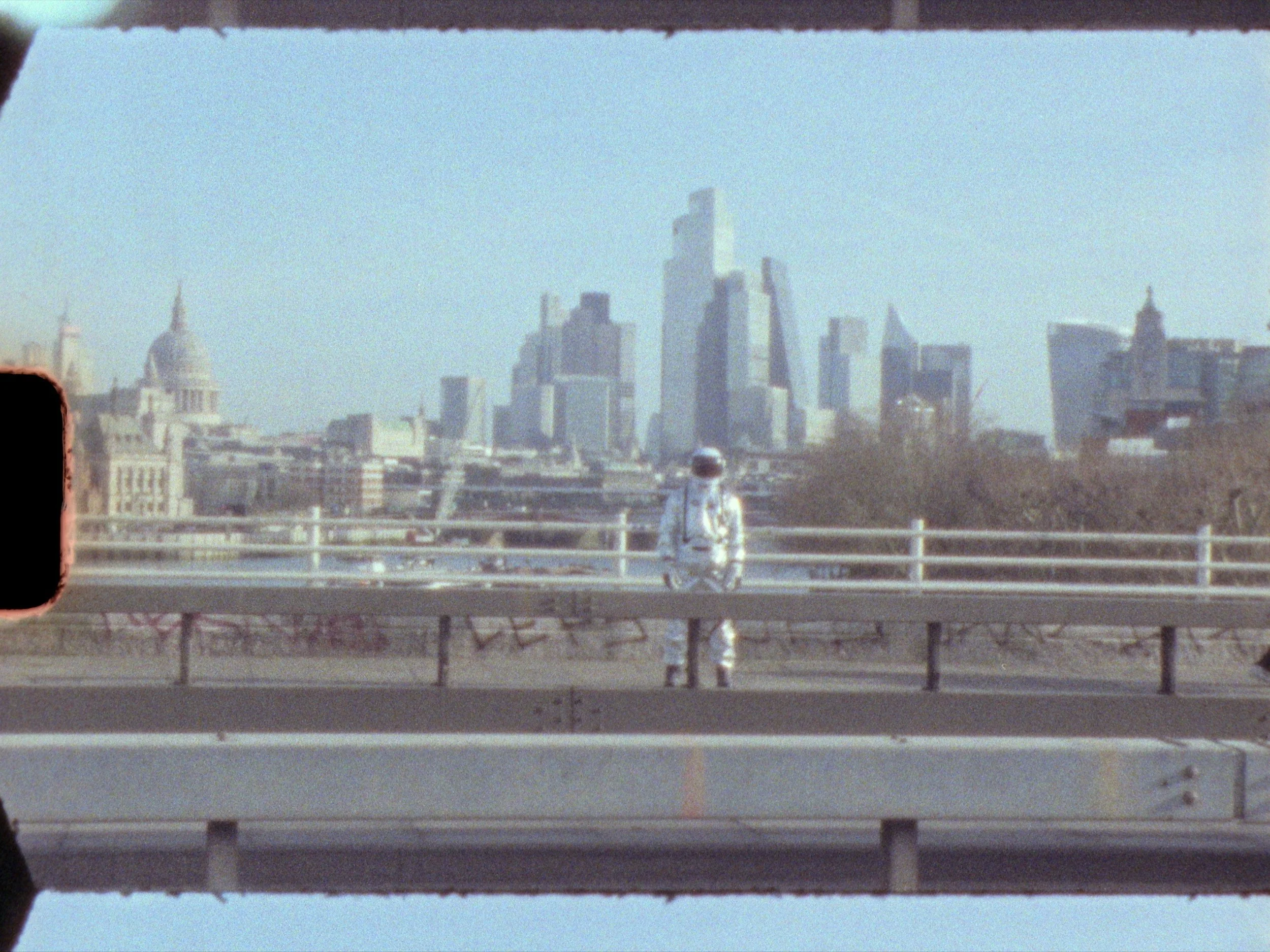 Astronaut stood in front of London skyscrapers and historic buildings are visible in the distance