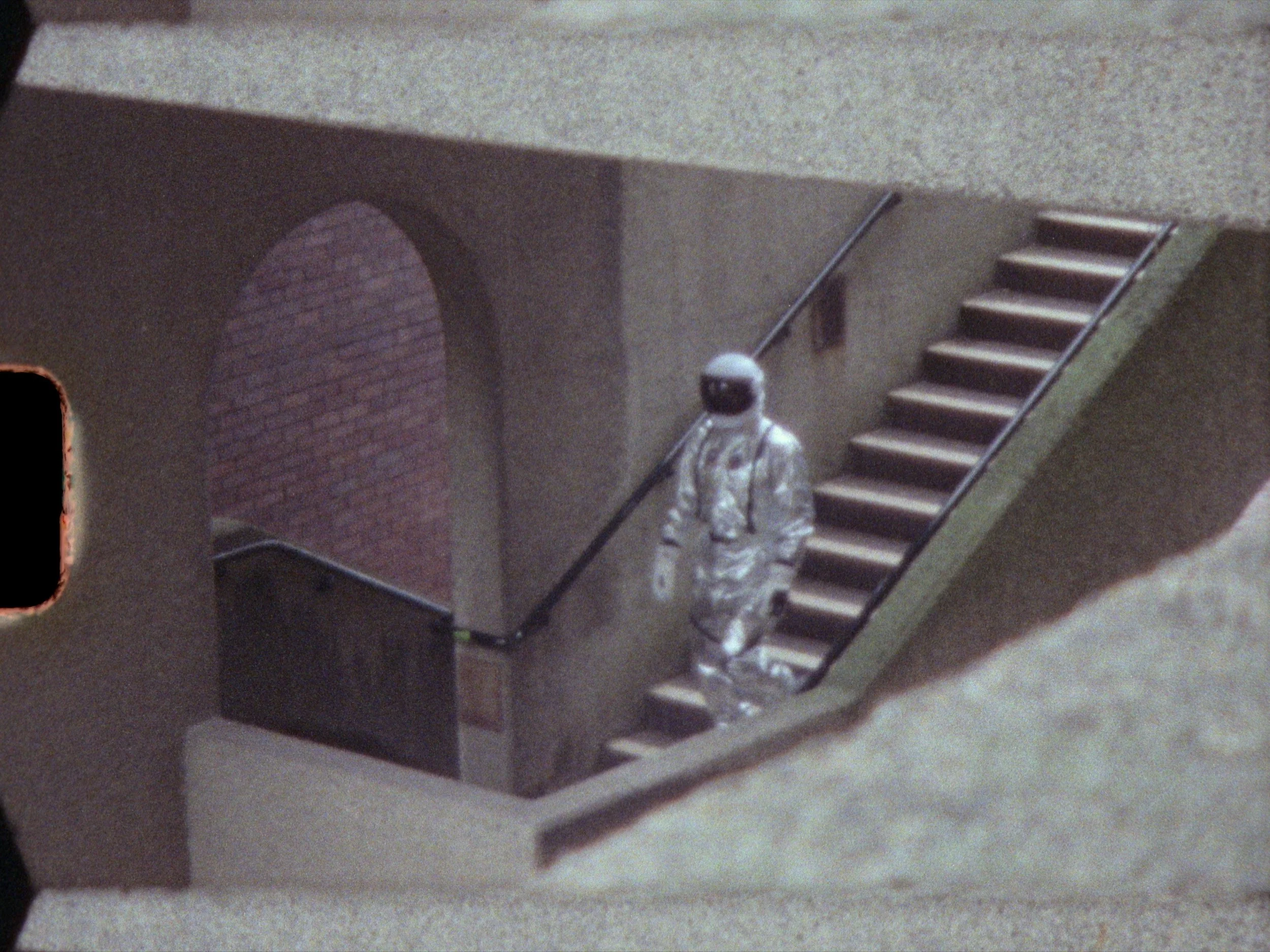 Astronaut walking on tiled staircase