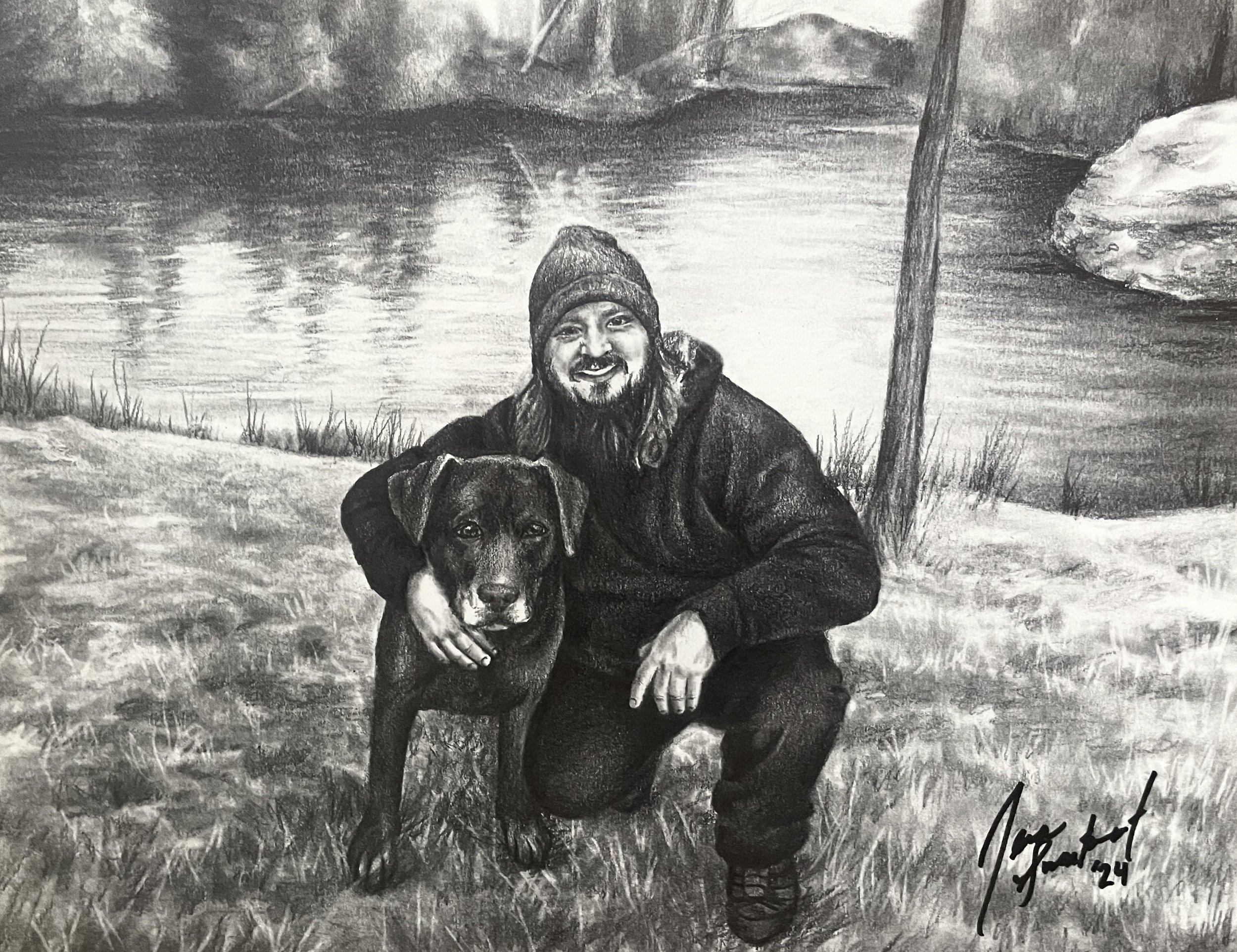 A black-and-white drawing of a man with long hair and a beard, wearing a beanie and a jacket, holding a dog that has long ears and a dark face. They are outdoors near a body of water with rocky and grassy terrain around them, and there is a tall, thi