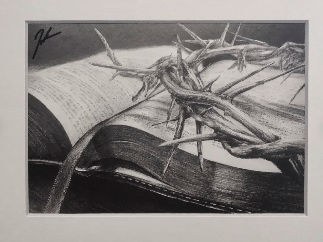 A black and white drawing of a Bible with a crown of thorns resting on open pages.