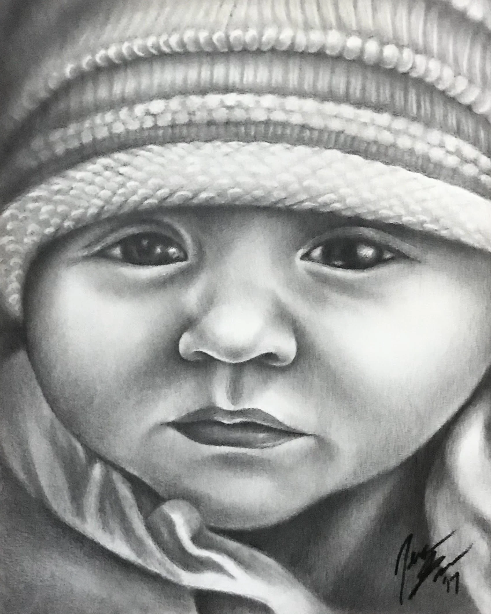 A black and white portrait of a young girl with large eyes, wearing a knit hat and a scarf.