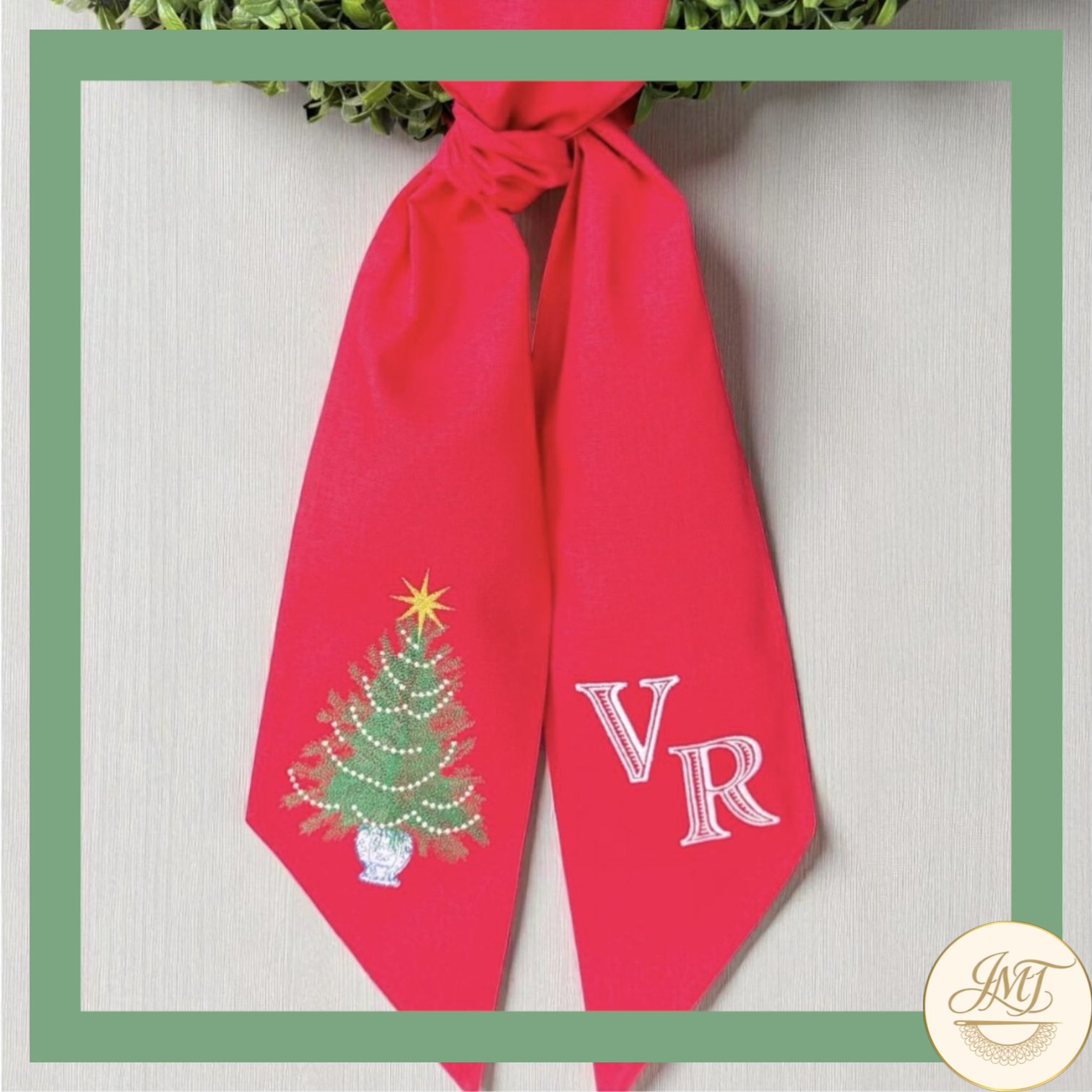 Christmas tree design and double initials on a red sash.