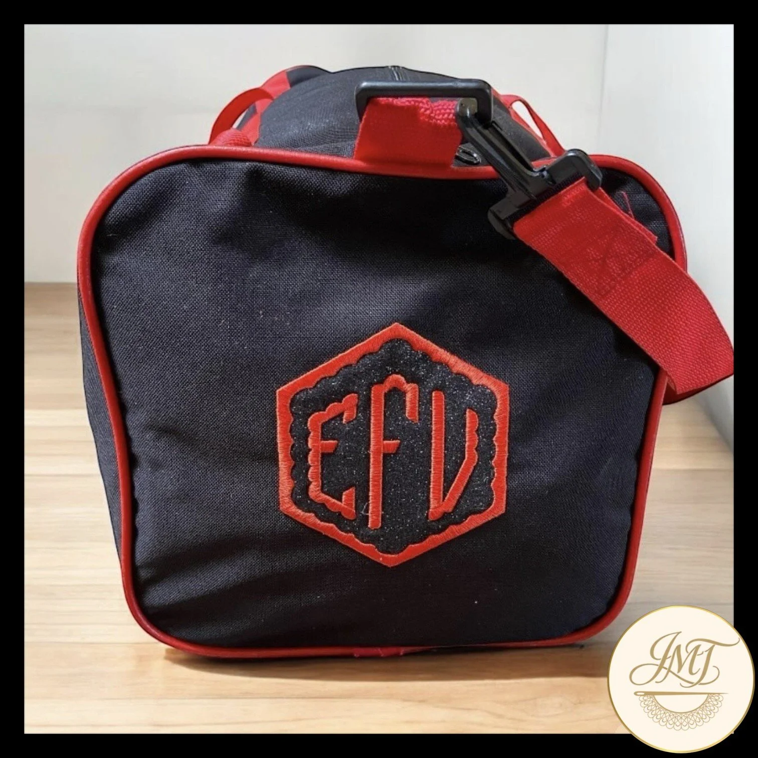This sports bag was damaged, so the affected area was covered with black glitter vinyl, and a new monogram was embroidered on top of the vinyl. Good as new!