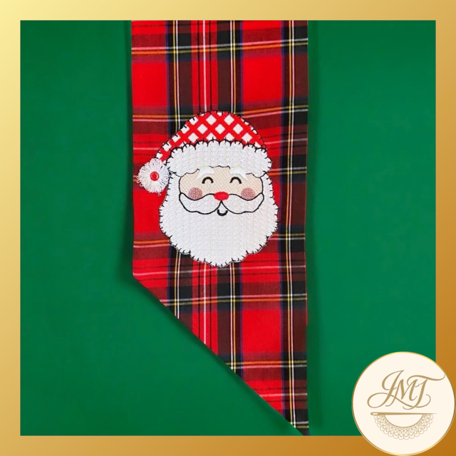 Santa with a cute fringe hat on a red plaid sash.