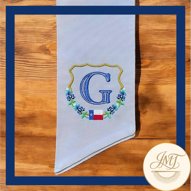 Texas Bluebonnet Premium Initial on a light blue sash.