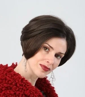 A woman (Fraidy Reiss) looking seriously at the camera.