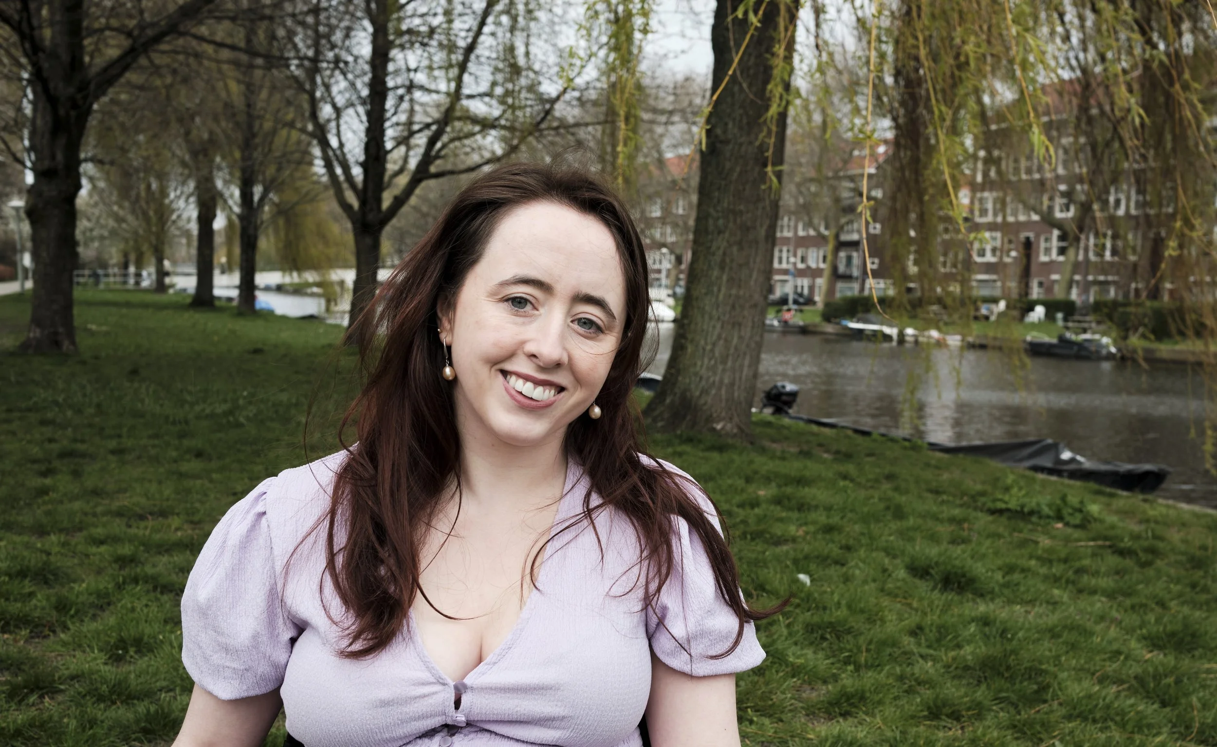 A woman (Niamh Ní Hoireabhaird) smiling at the camera.