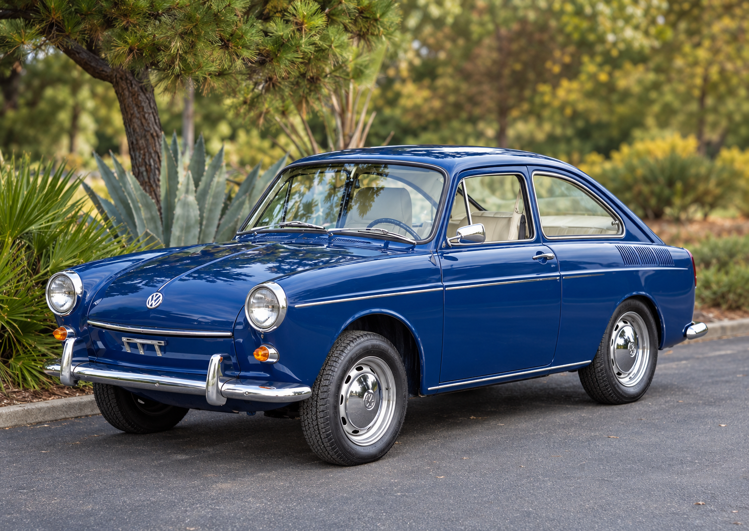 Blue vintage Volkswagen fastback parked outdoors beneath trees.