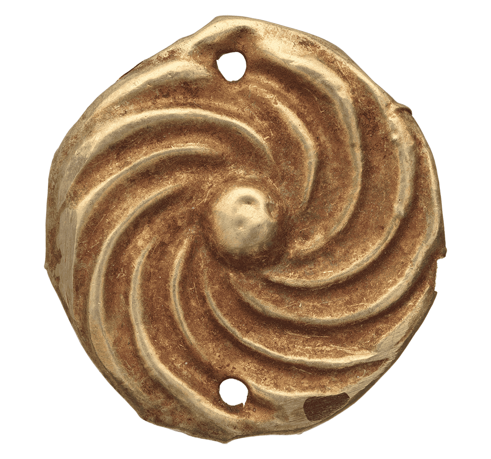 Close-up of a rusted, spiral-shaped metal object with two small holes, viewed from above.