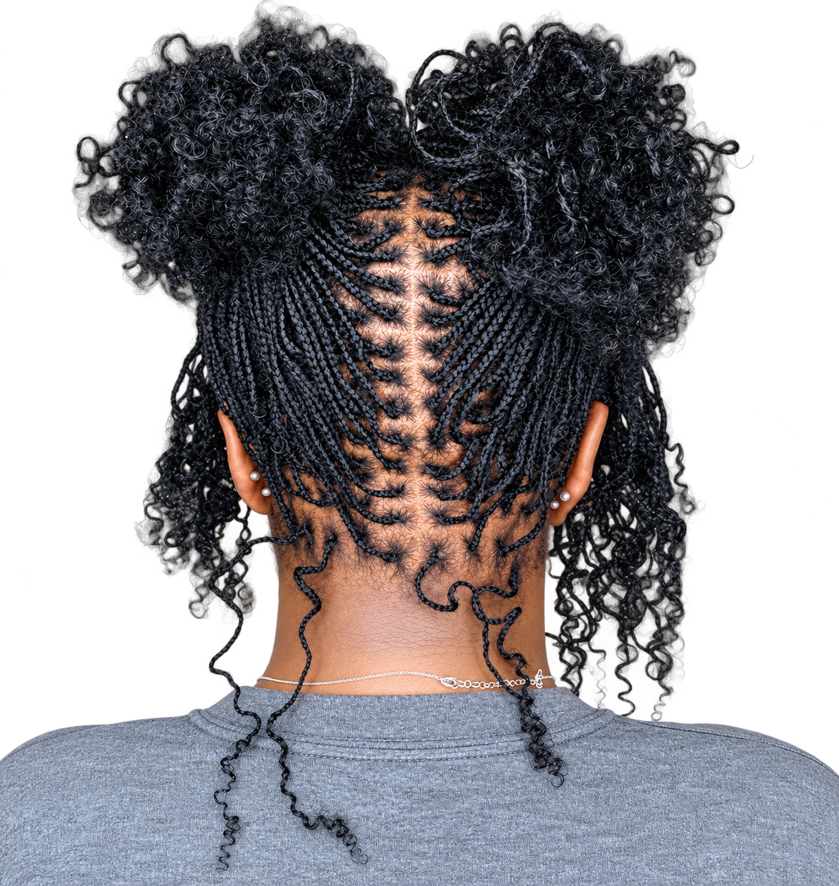 Back view of a woman with intricate braids and curly hair styled in two puff ponytails, wearing pearl earrings and a gray shirt.