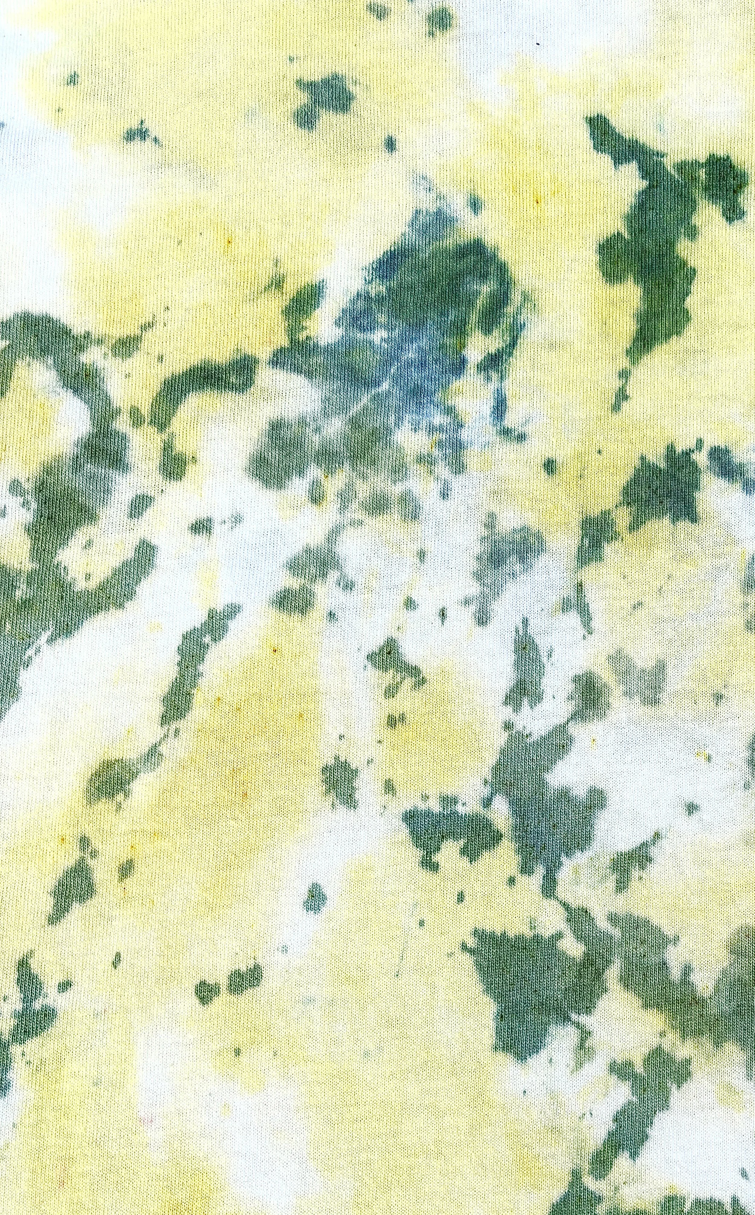 Abstract watercolor painting featuring green, yellow, and blue splashes and streaks.