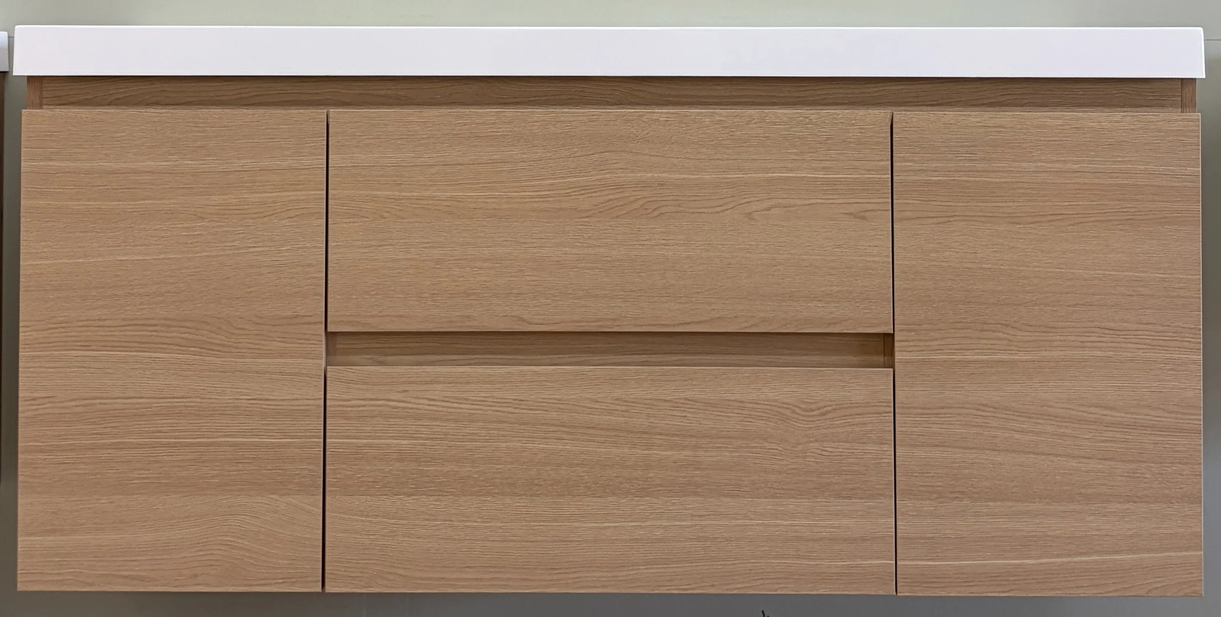 A wooden cabinet with multiple drawers and a white countertop
