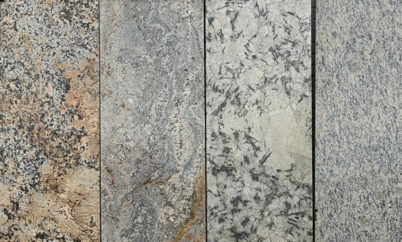 Close-up of five different textured stone or concrete slabs with varied gray, beige, and black color patterns.