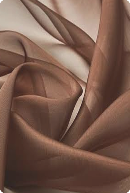 Close-up of brown fabric with soft, flowing folds.