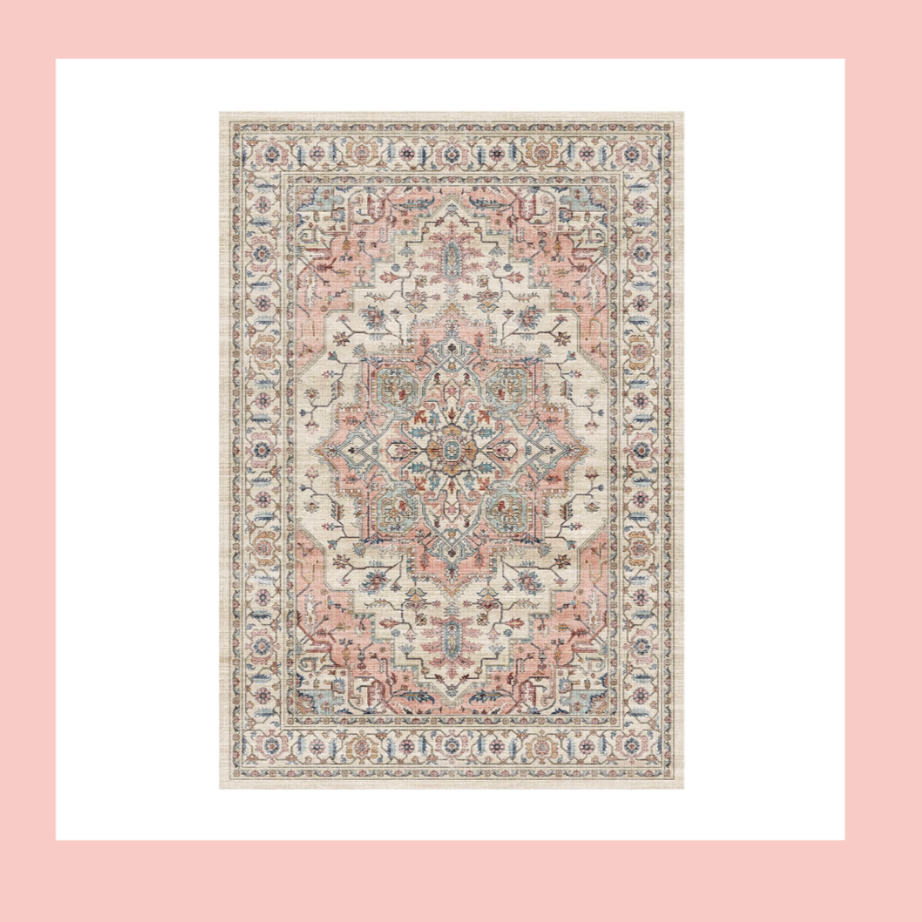 A vintage, patterned area rug with an intricate design featuring floral and geometric motifs in pastel shades of pink, blue, and beige.