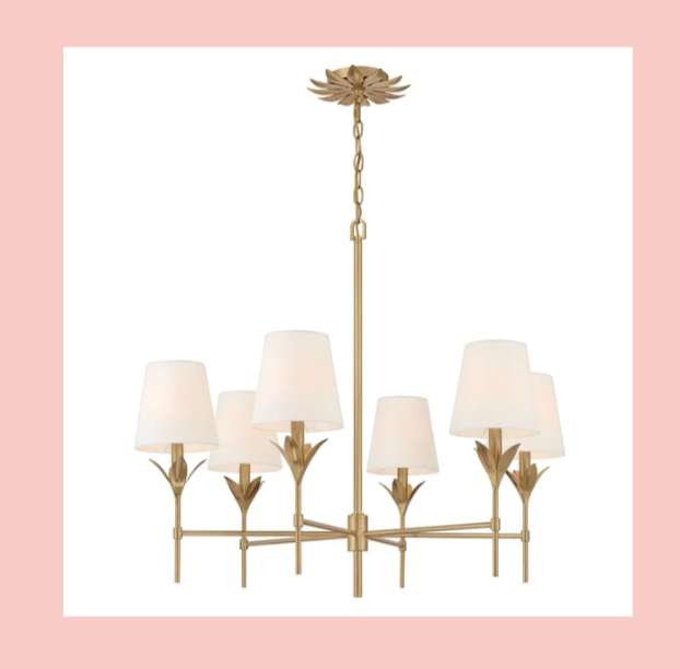 A chandelier with six lampshades and a gold-colored floral design.