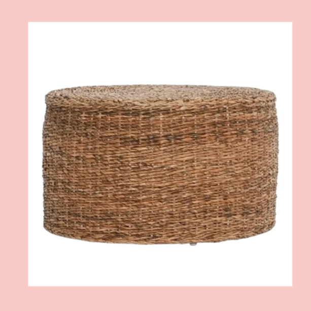 Round woven wicker ottoman or stool with a flat top.