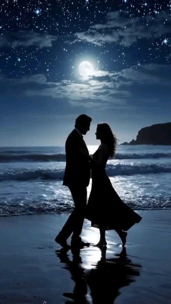 Silhouetted couple dancing on a moonlit beach beneath a star-filled sky