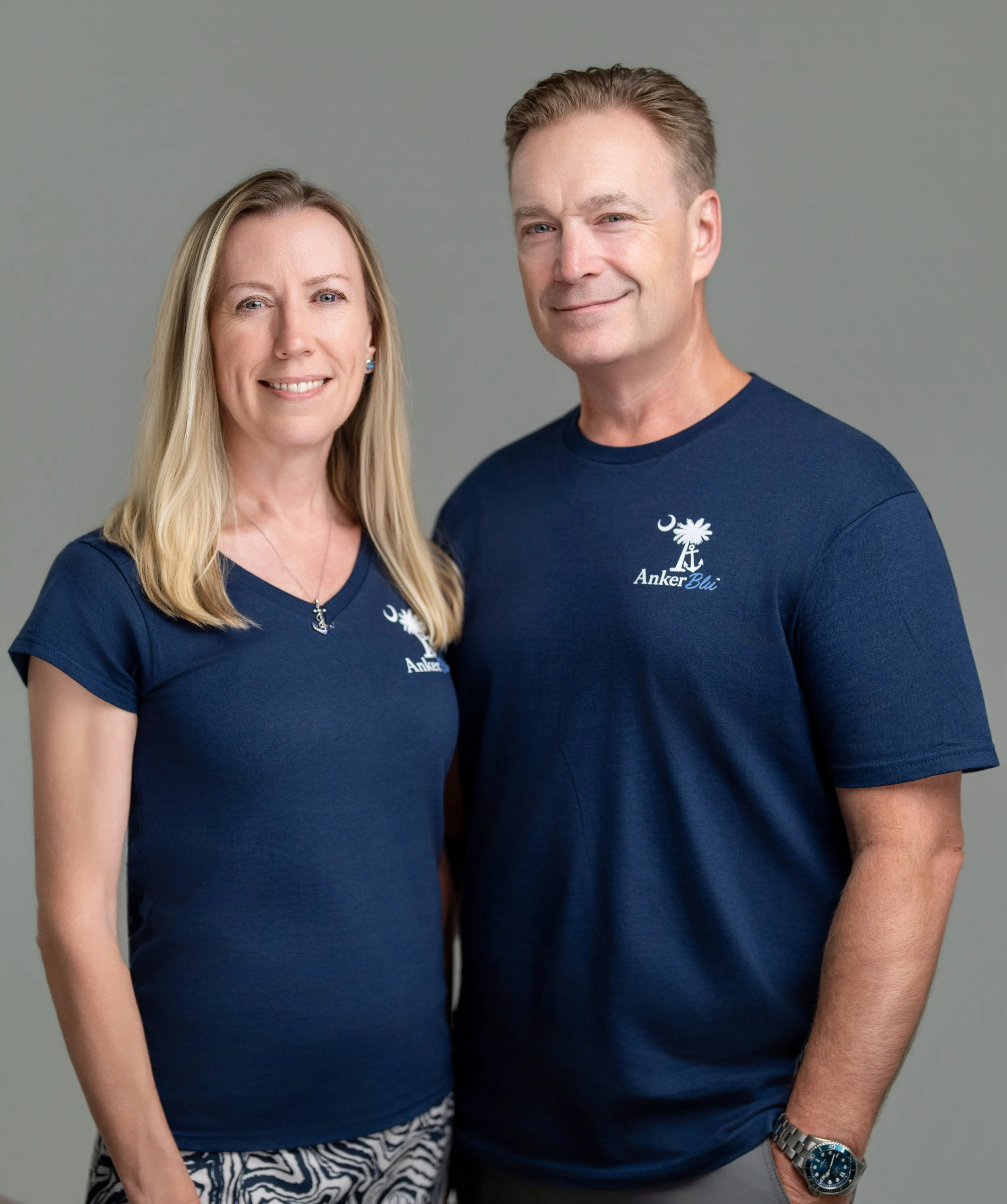 Anker Blu co-owners standing together in navy shirts