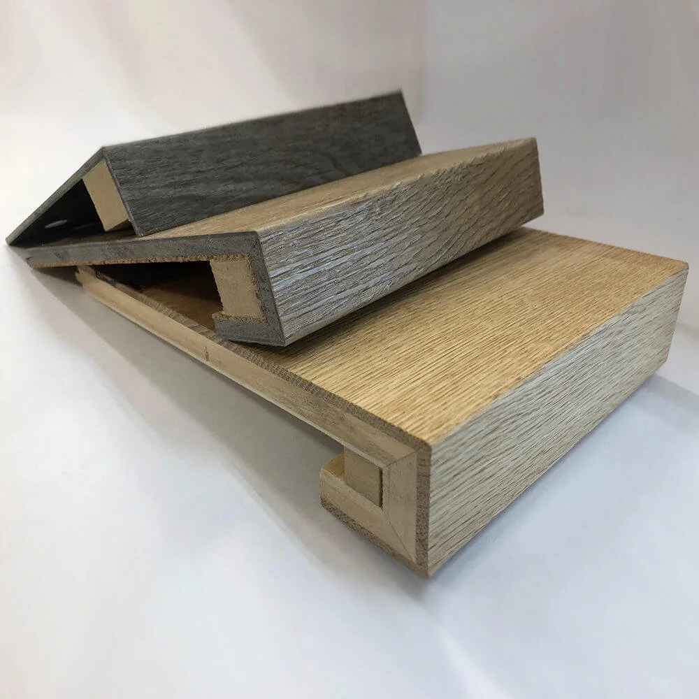 Three different wood samples stacked together, showcasing various textures and colors.