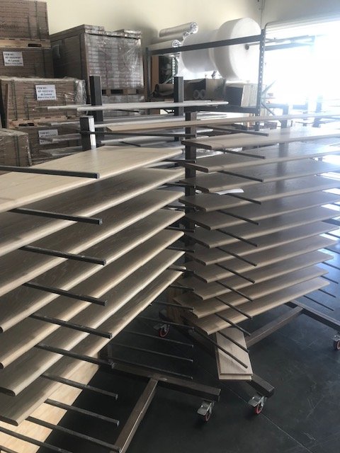 Empty display racks on wheels in a warehouse or storage area.