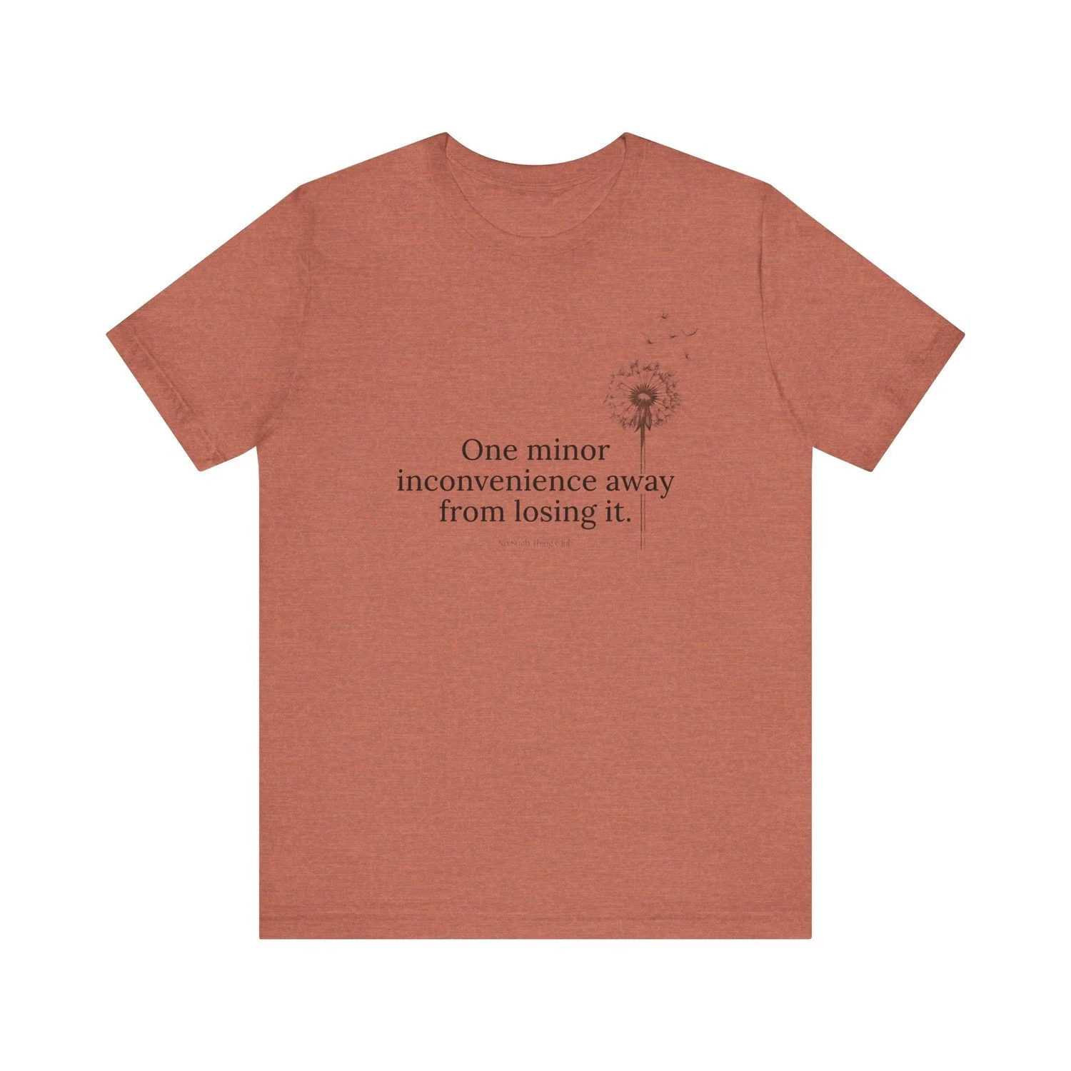 The One Minor Inconvenience tee laid flat, printed in black with a dandelion going to seed