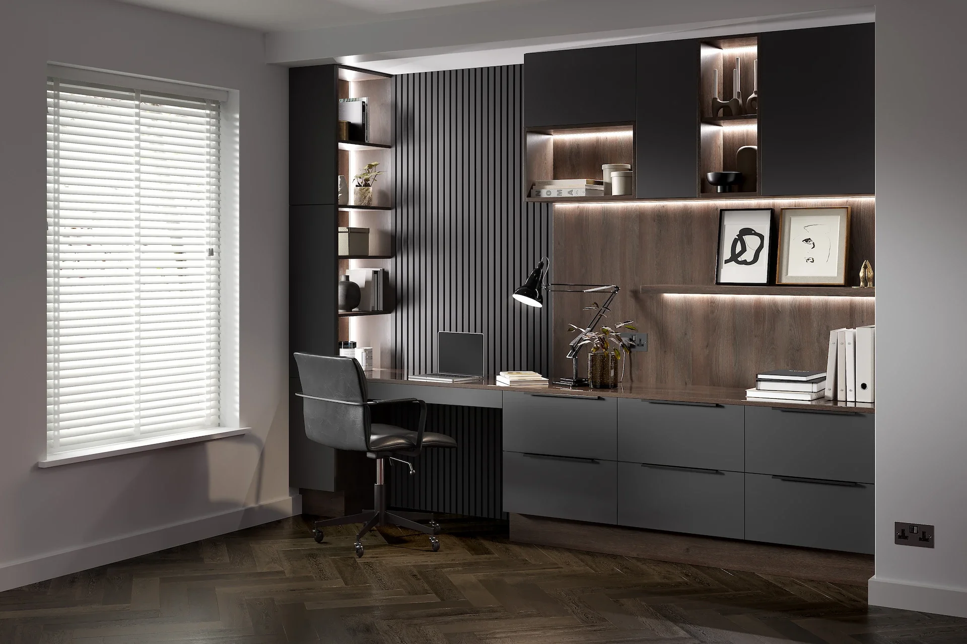 Modern home office with black and gray furniture, decorated with framed artwork and decorative objects, next to a window with white blinds