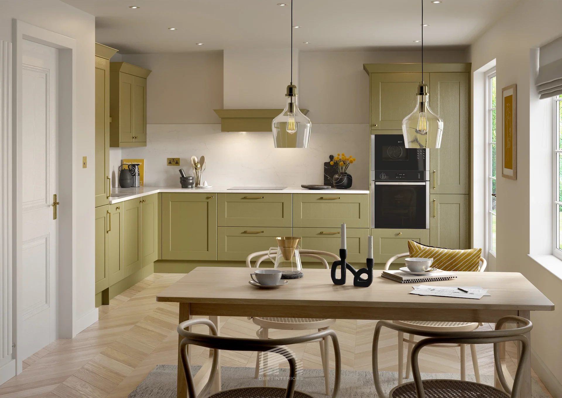 Modern kitchen with sage green cabinets, white walls, and a wooden dining table with chairs. Pendant lights hang above the table, and there are windows on the right side.