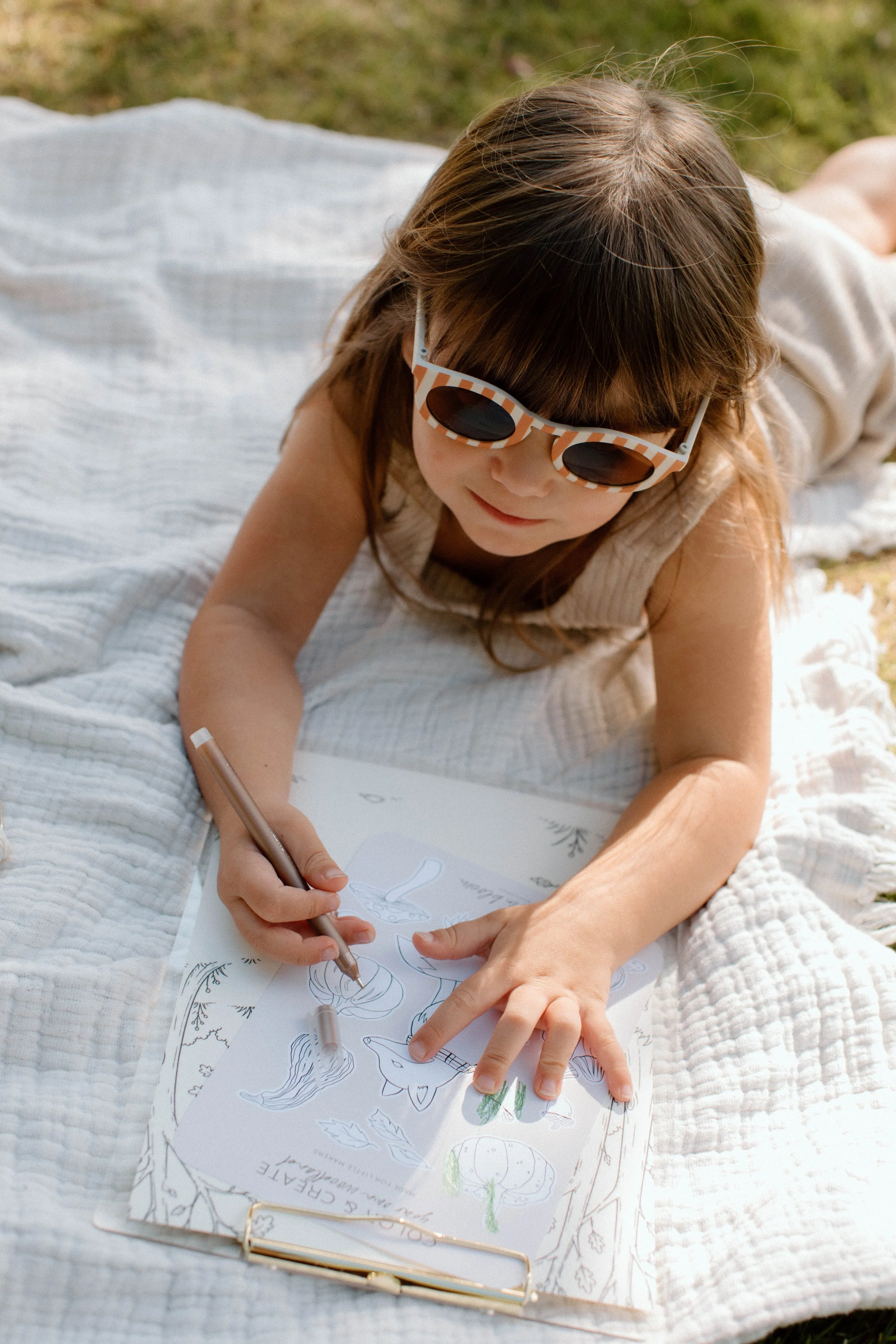 Child coloring the Woodland Color + Create fall sticker sheet outdoors