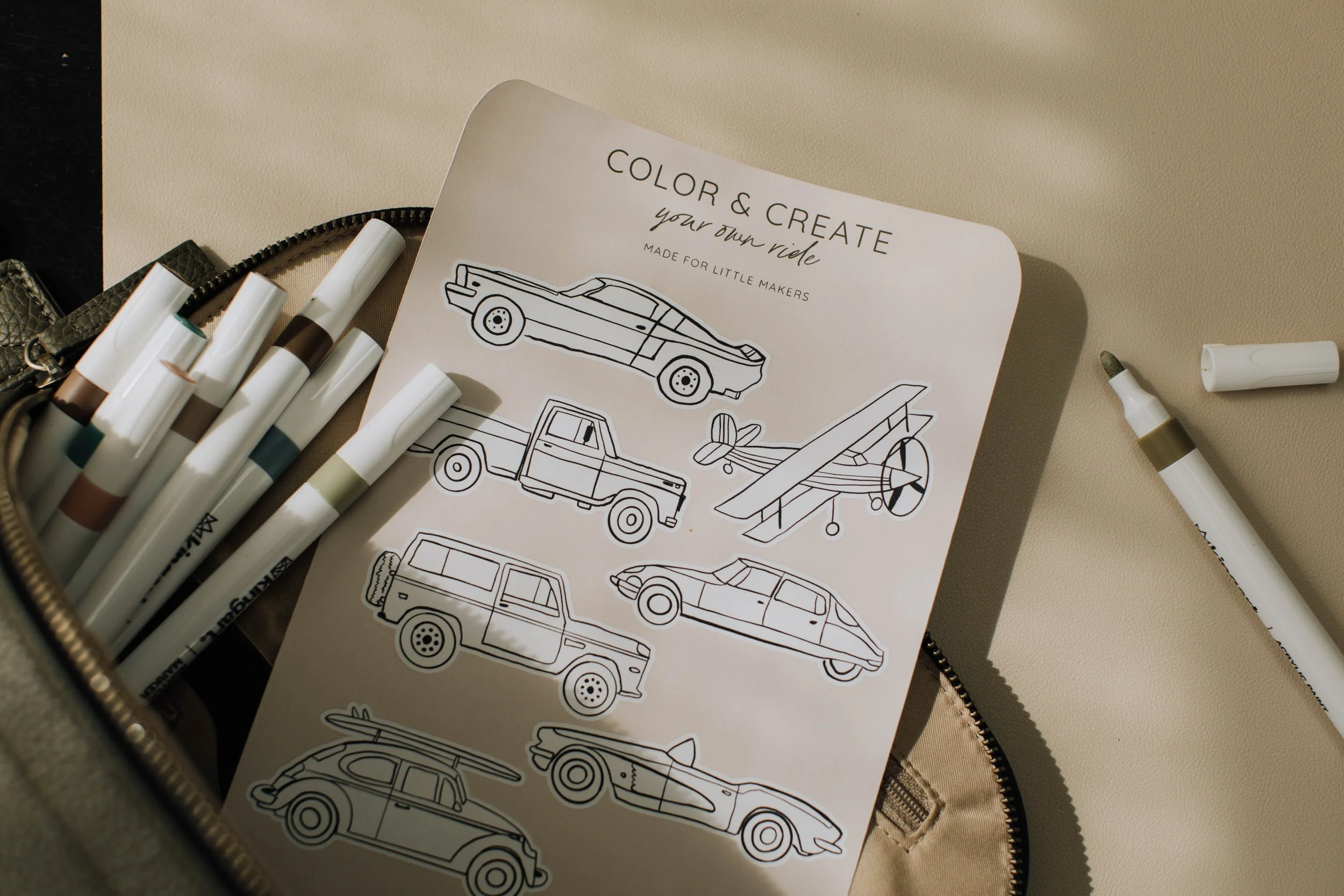 Cars Color + Create sticker sheet with illustrated cars, trucks, and an airplane for kids to color and peel.
