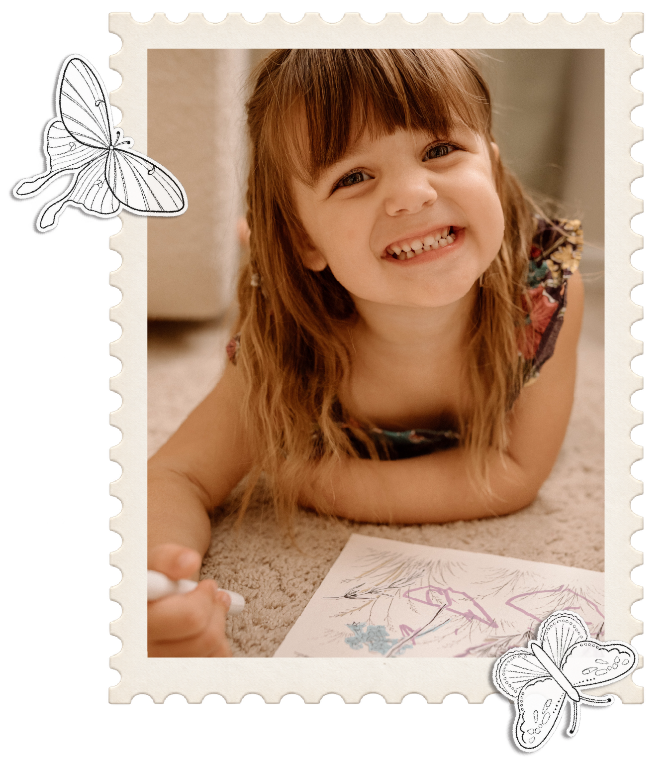 Young child smiling while coloring a Littles in Bloom activity sheet.
