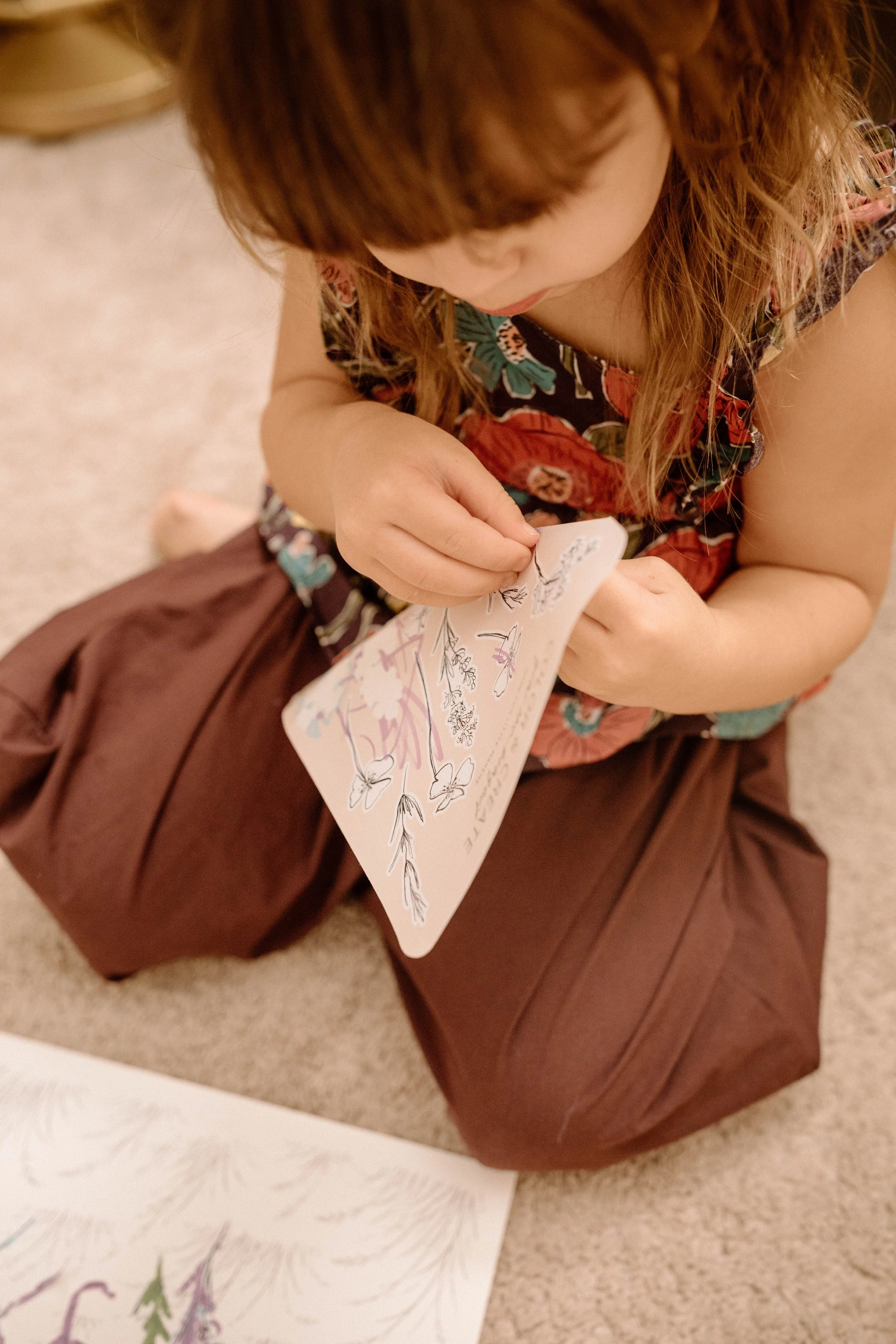 child-using-flower-color-create-sticker-sheet.jpg