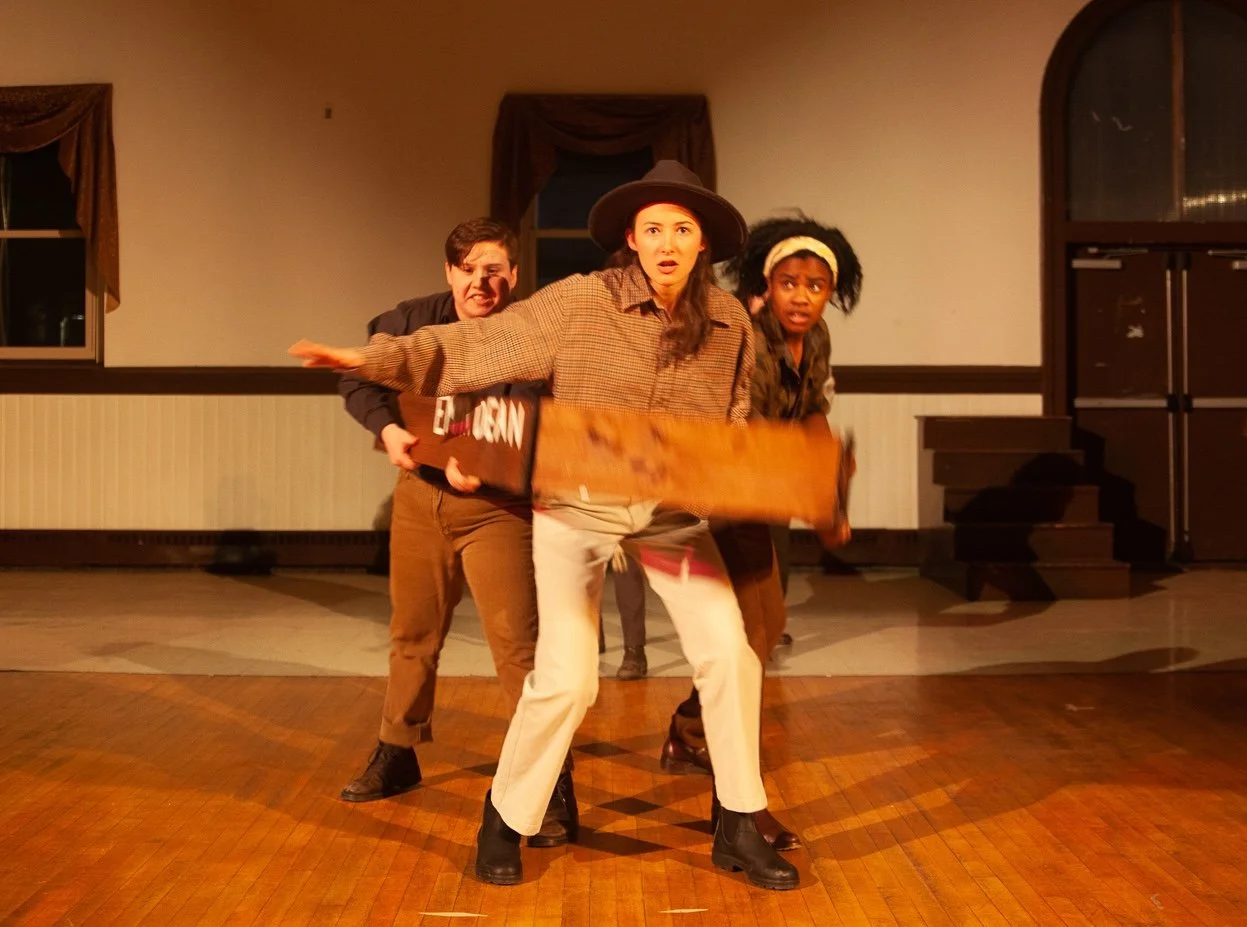 Three students look to camera dressed in 1800s era menswear