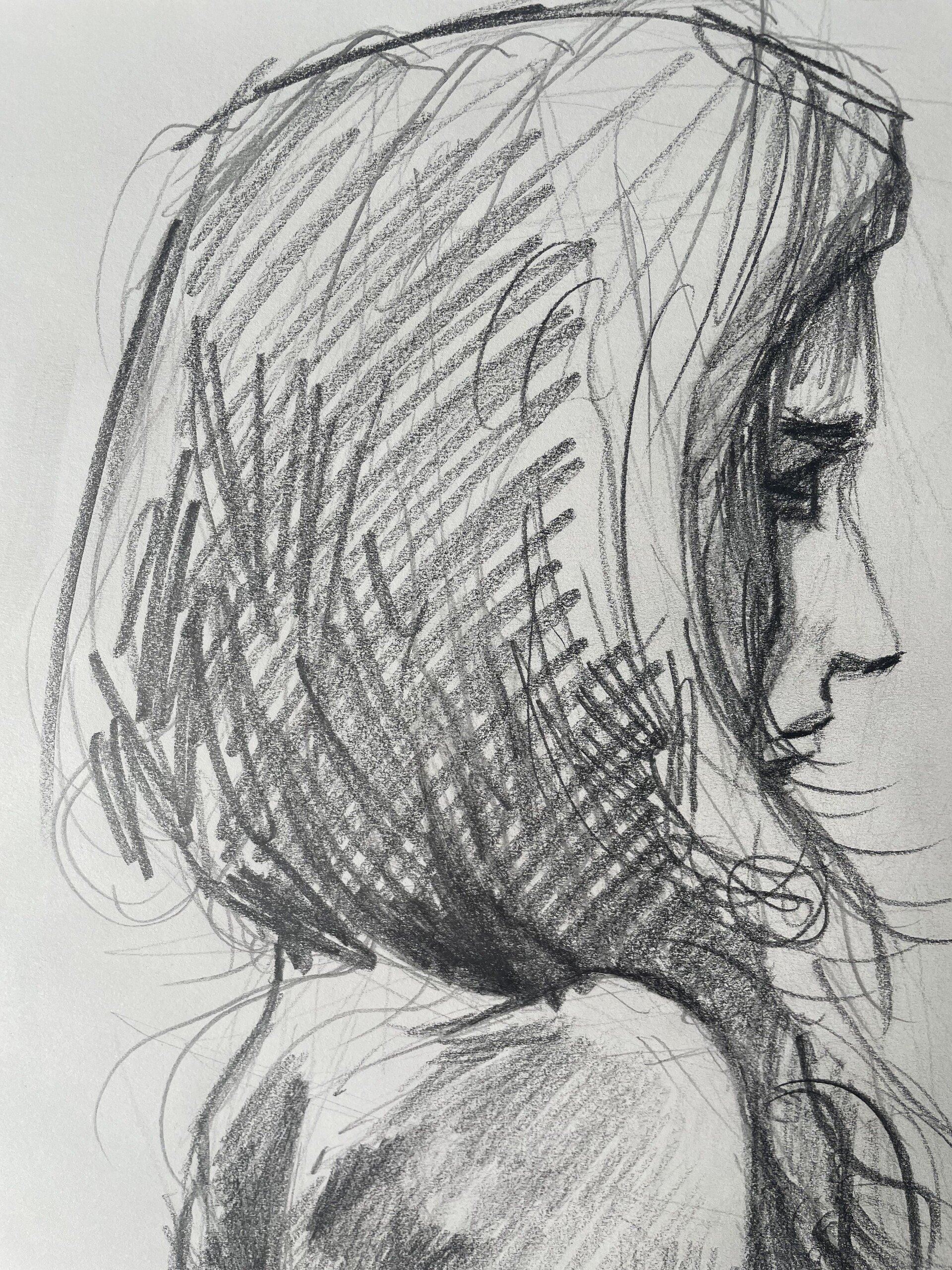 A pencil sketch of a person in profile view with long hair, looking down.