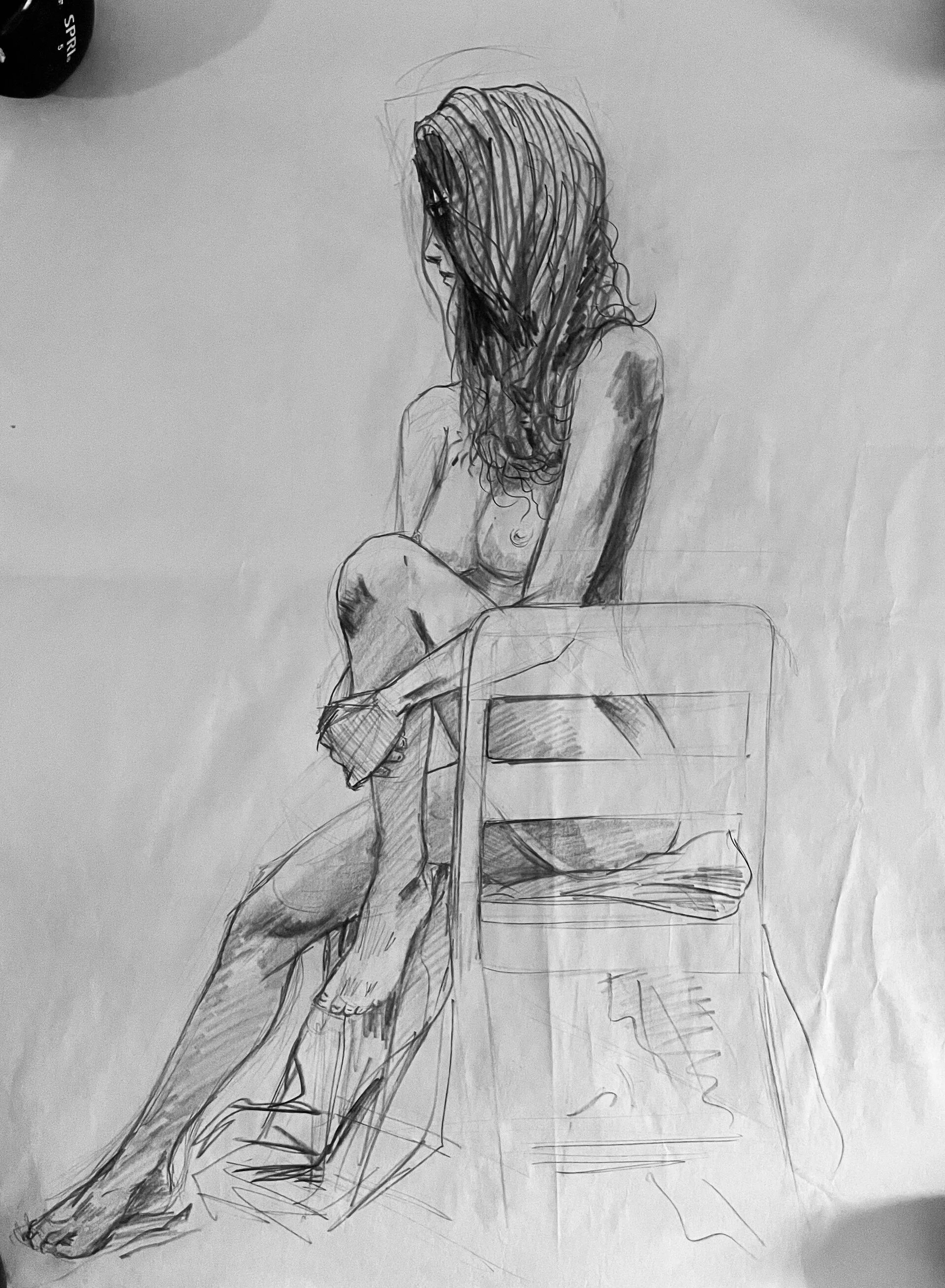 A black and white sketch of a woman with long, curly hair sitting on a chair, with her head turned downward and her arms resting on her lap.