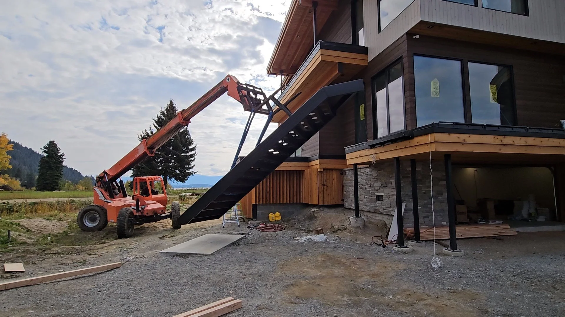 Large machinery moving a large metal staircase.