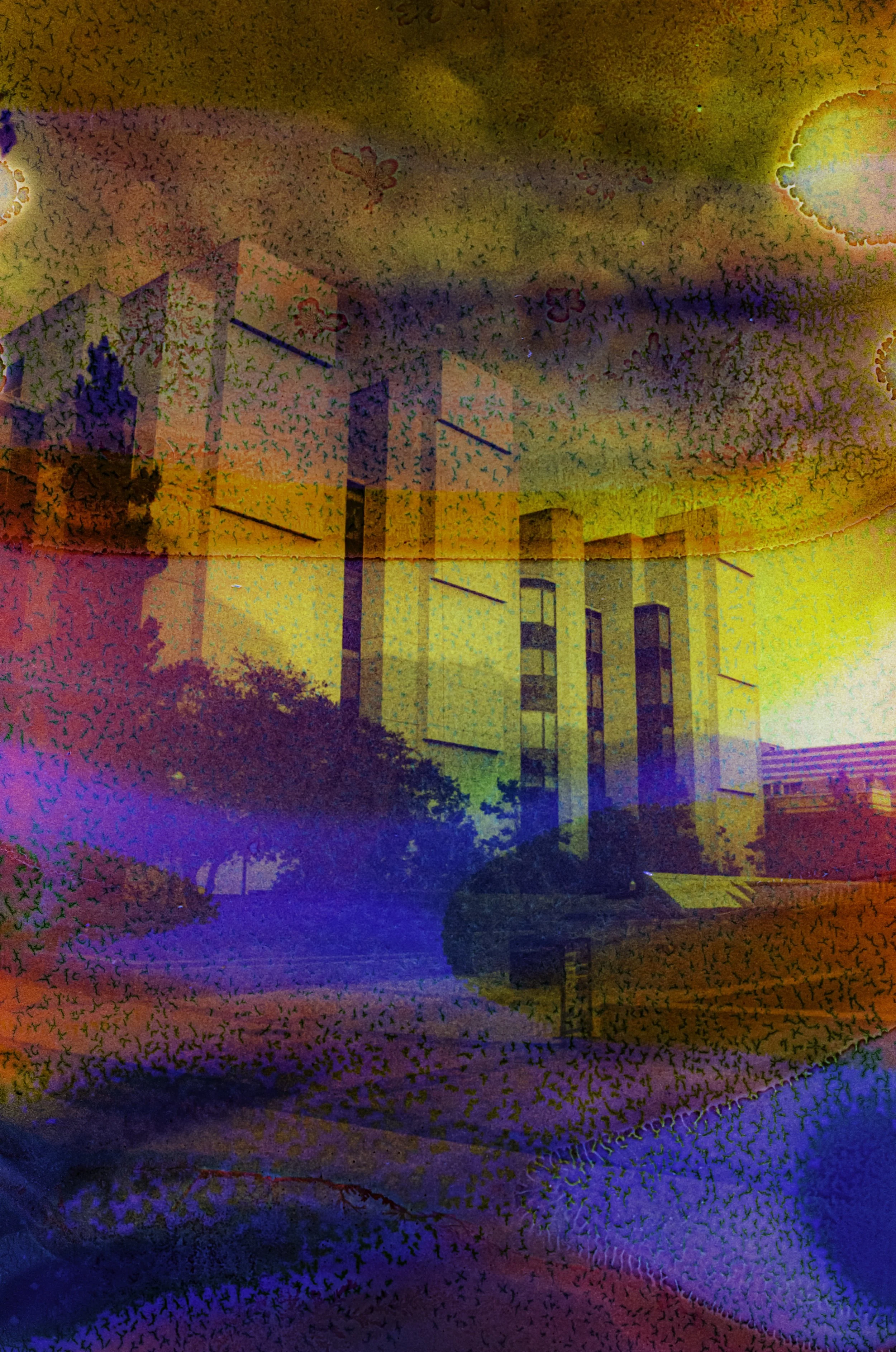 A UCLA campus building framed by overlapping red, orange, blue, and violet chemical bands.