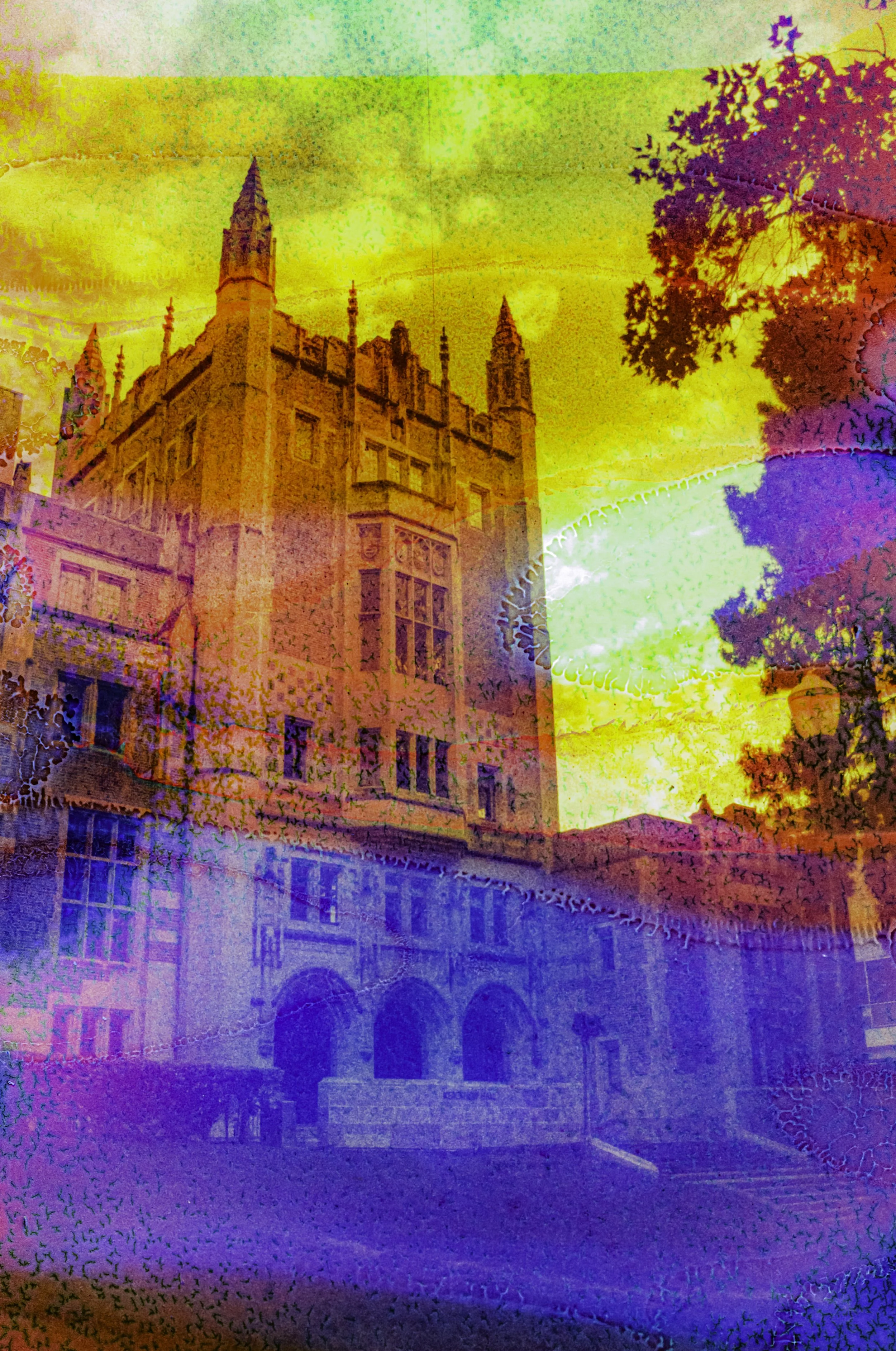 A Gothic Revival building at UCLA surrounded by trees and layered with yellow and blue chemical streaks.