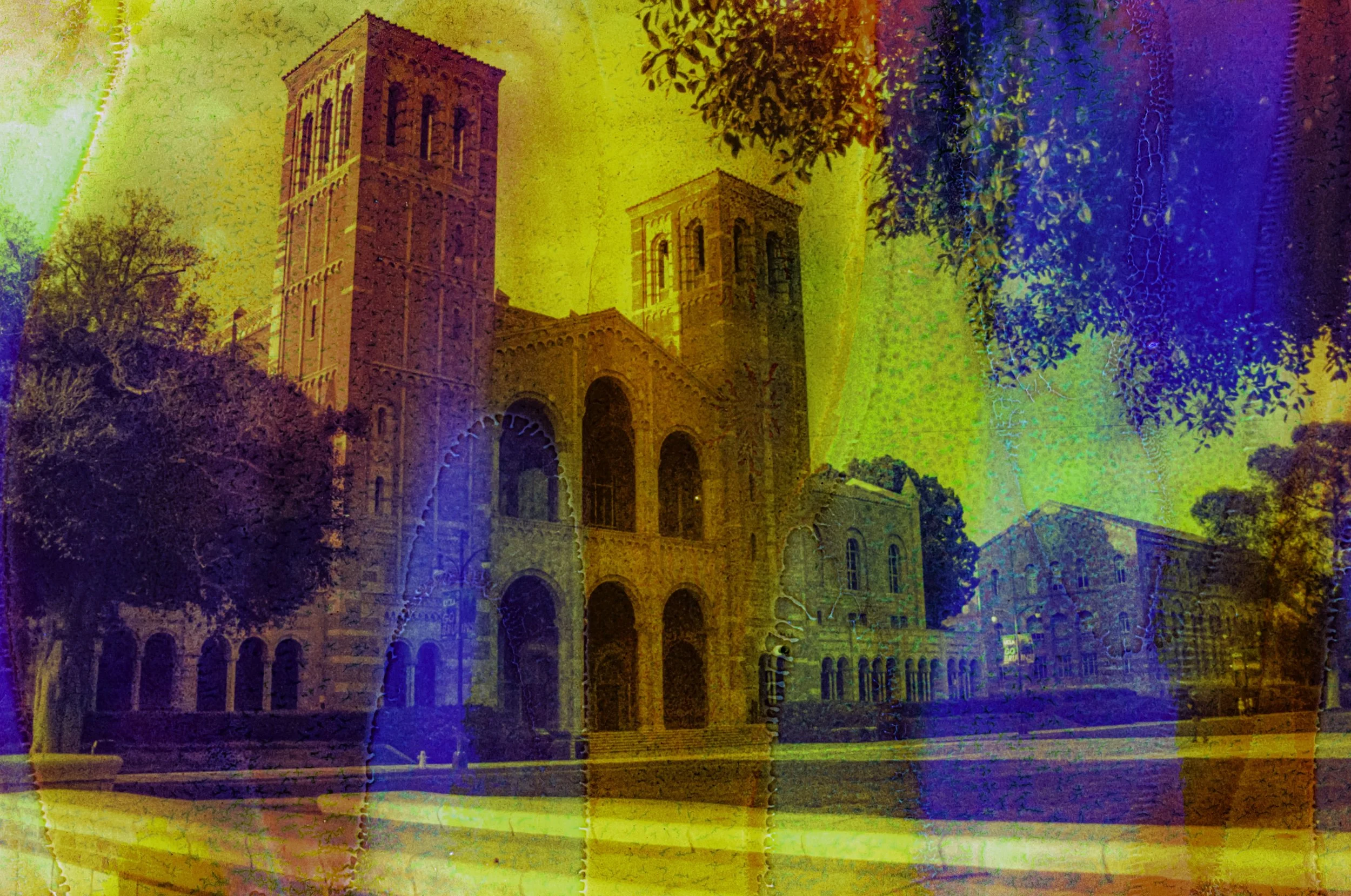 Royce Hall seen across the UCLA campus through layered red, orange, blue, and violet chemical color.
