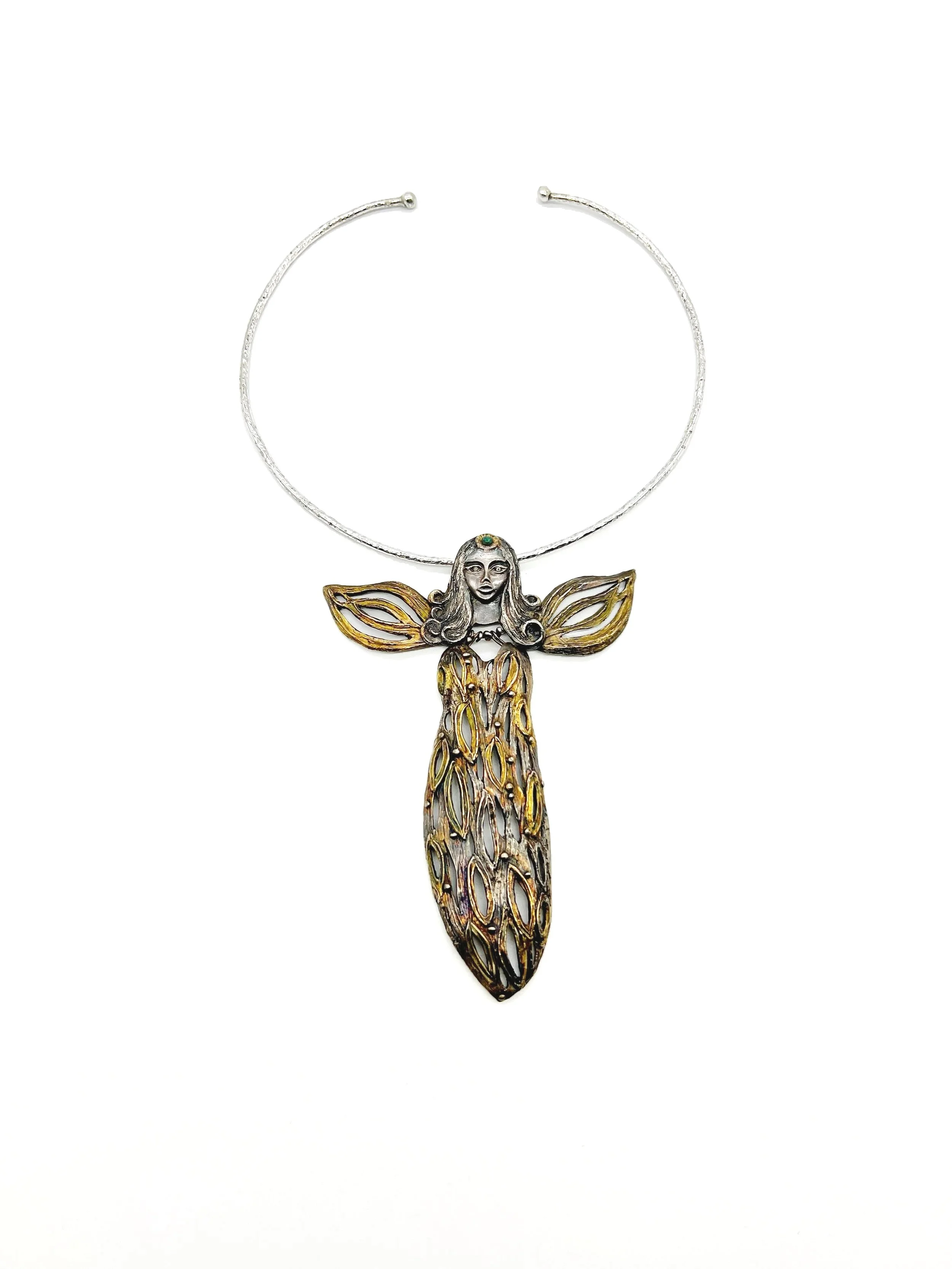 A necklace featuring a butterfly with a female figure with long hair on its head, intricate wings, and long, detailed body, set against a white background.