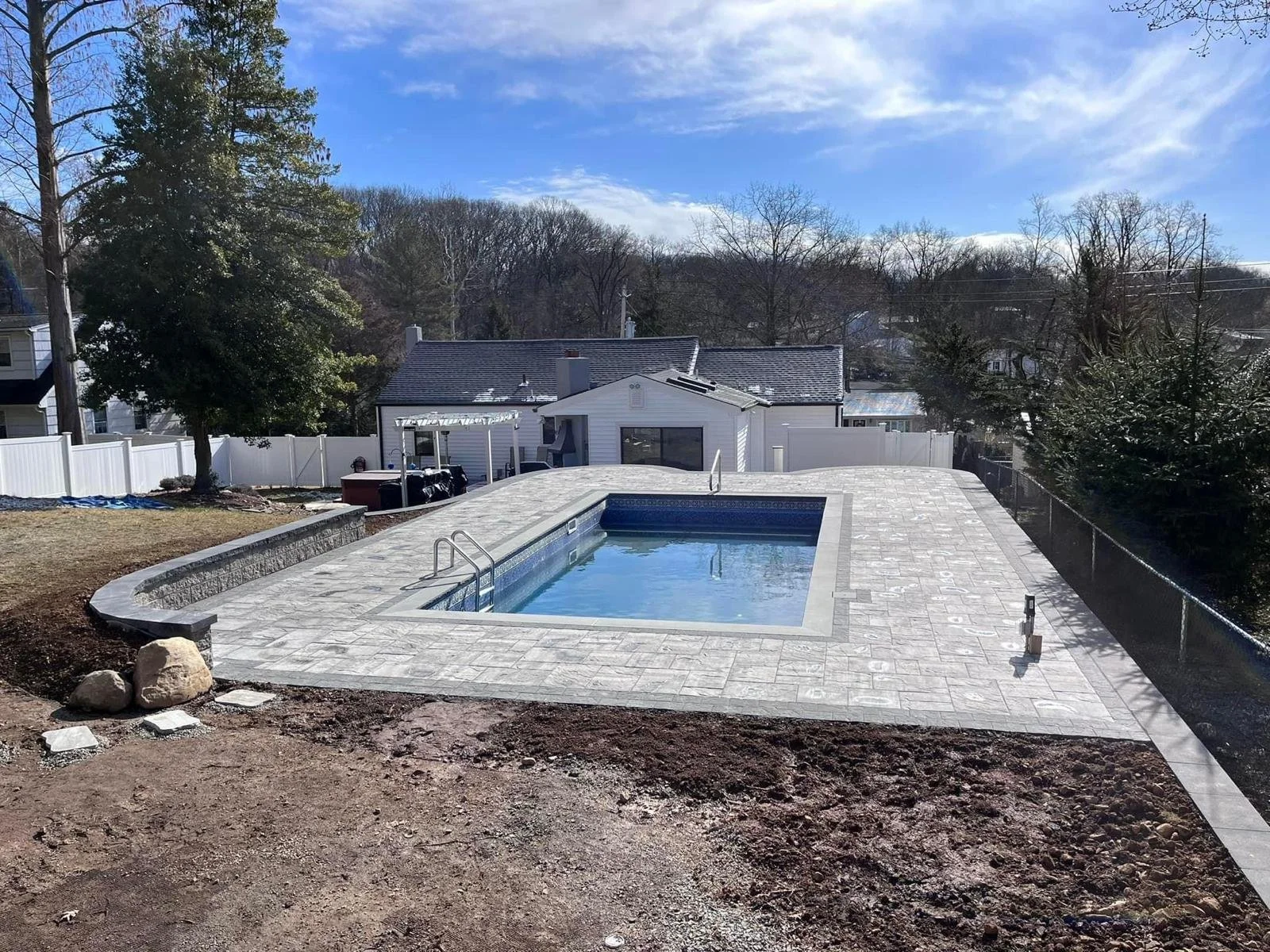 Premium concrete paver patio installation around swimming pool deck in Lehi, UT — Aspen Stone Design