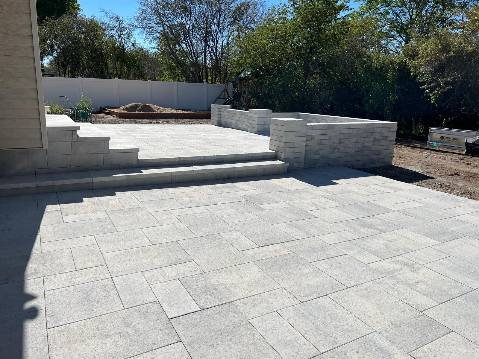 High-end outdoor living space and custom paver patio design in Saratoga Springs, UT — Aspen Stone Design