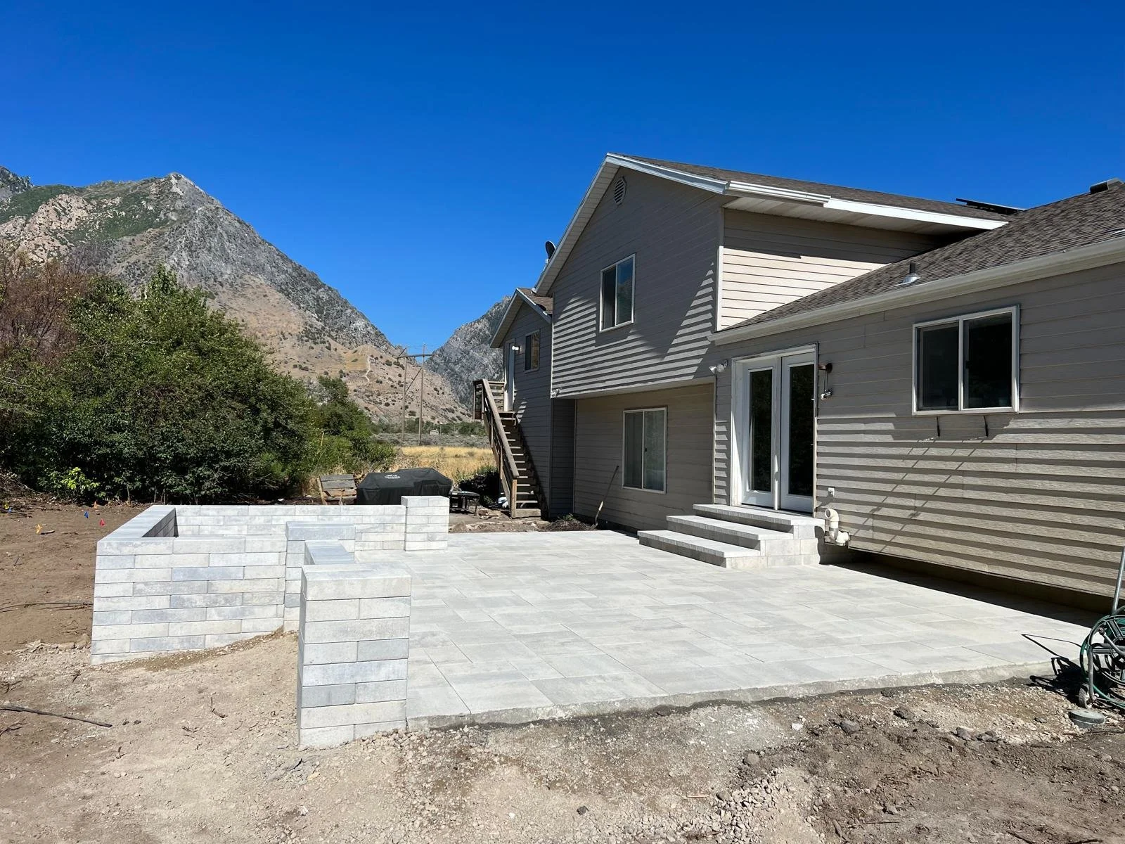 Modern paver patio extension and backyard stone hardscaping in Draper, Utah — Aspen Stone Design