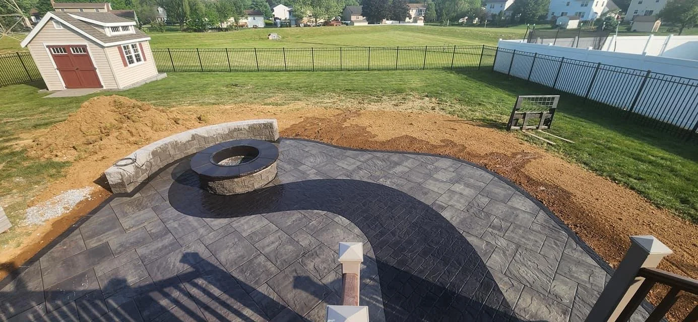 Circular custom paver patio installation with stone fire feature in Highland, Utah — Aspen Stone Design