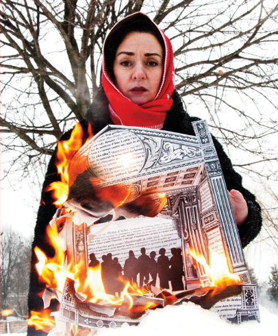 A woman in a red headscarf and black coat burns a framed newspaper clipping outdoors in a snowy environment with barren trees in the background.