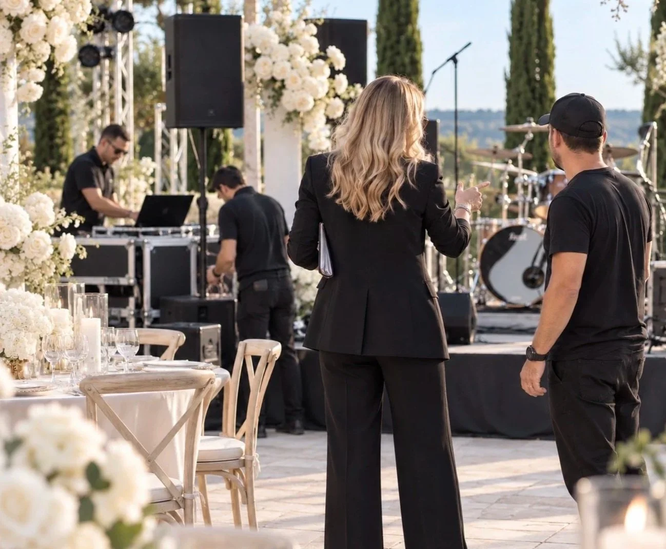 LBC Events & Co. Wedding Coordination Service card. outdoor wedding setup with Sabina speaking to the production crew
