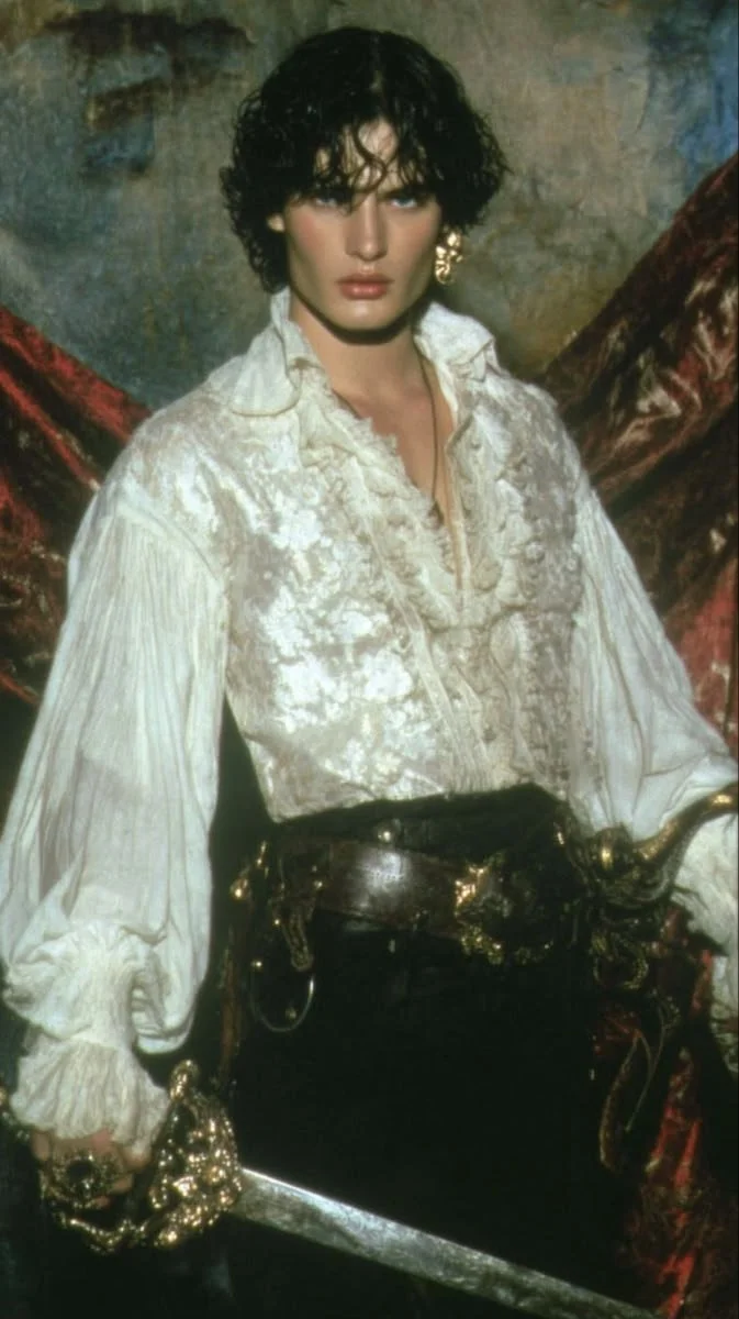 Renaissance menswear with a billowy ivory shirt and brocade waistcoat