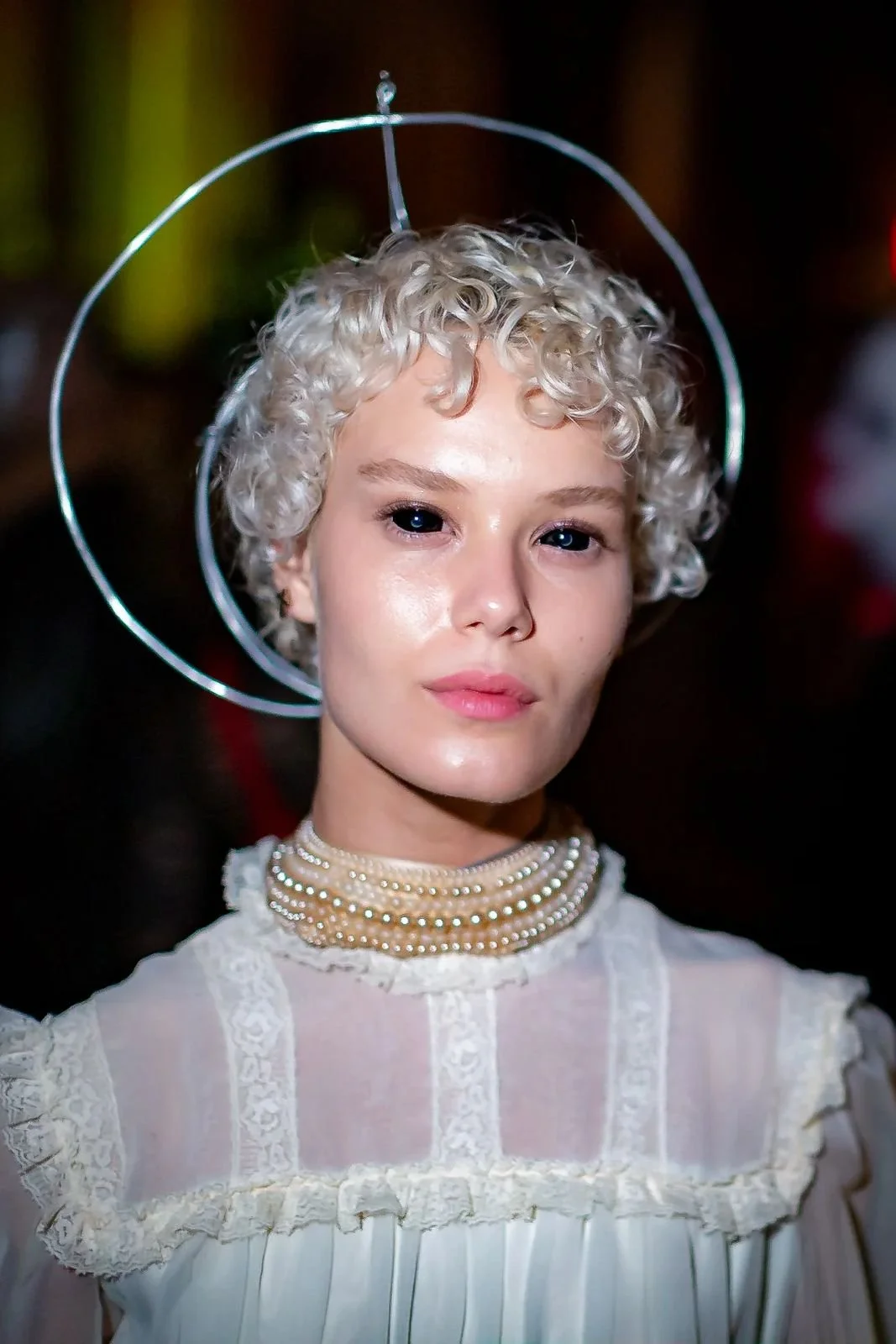 White lace costume and circular halo. Past Astarte Creative performance.