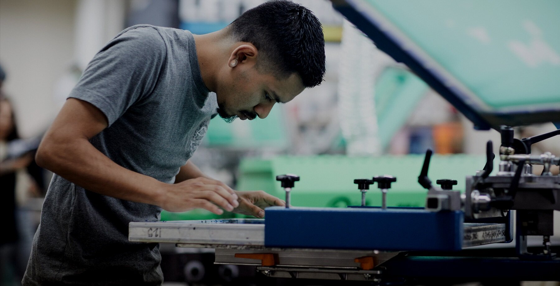 A man working on a machine in a workshop.